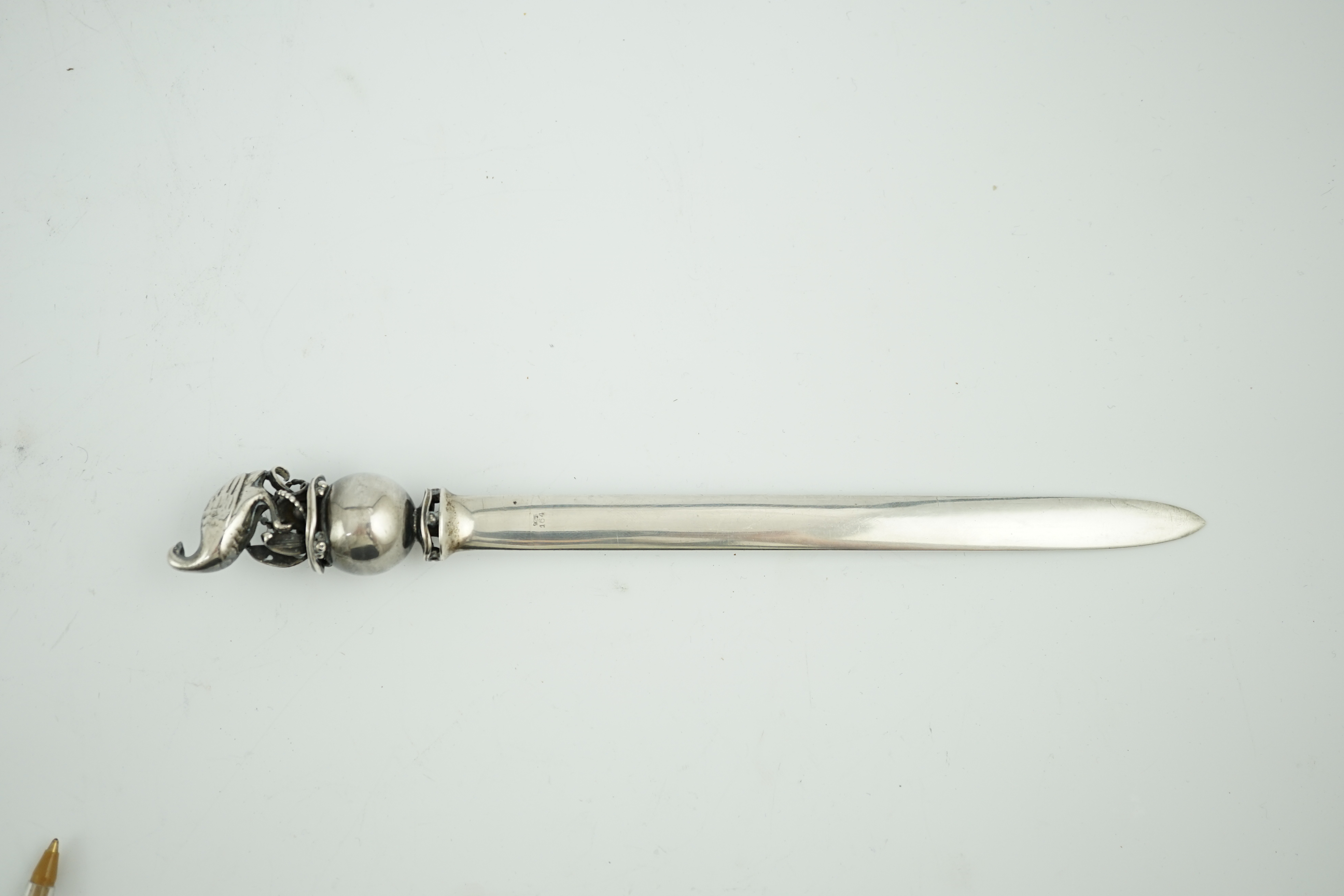 A Georg Jensen sterling silver letter opener, with game bird and sphere finial